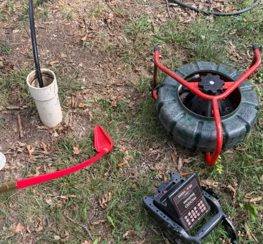 Sewer camera reel and monitor set up on the lawn for a drain inspection